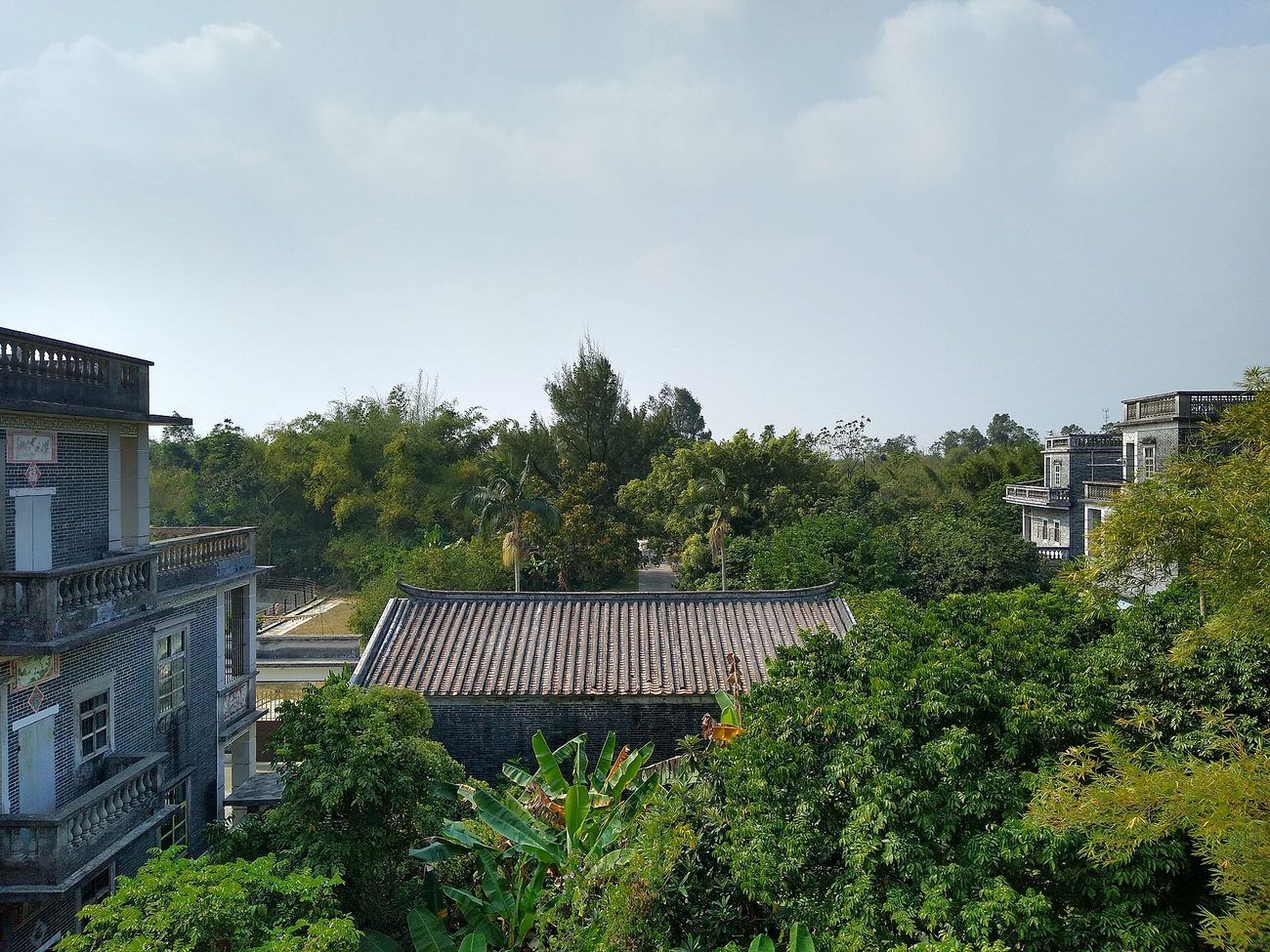 Towers and village roofs among dense bamboo in the Majianglong cluster — the quieter alternative to Zili