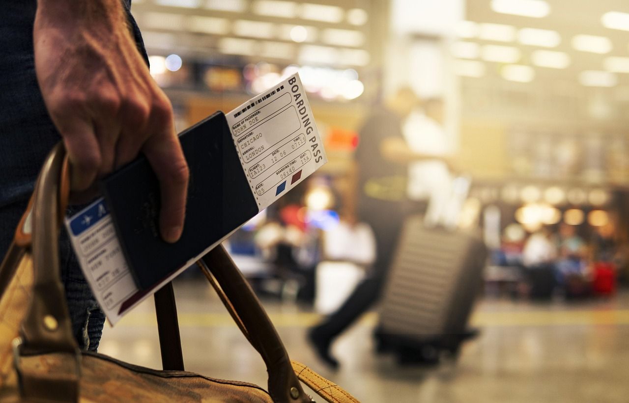 A boarding pass and passport — the two documents the transit rule turns on