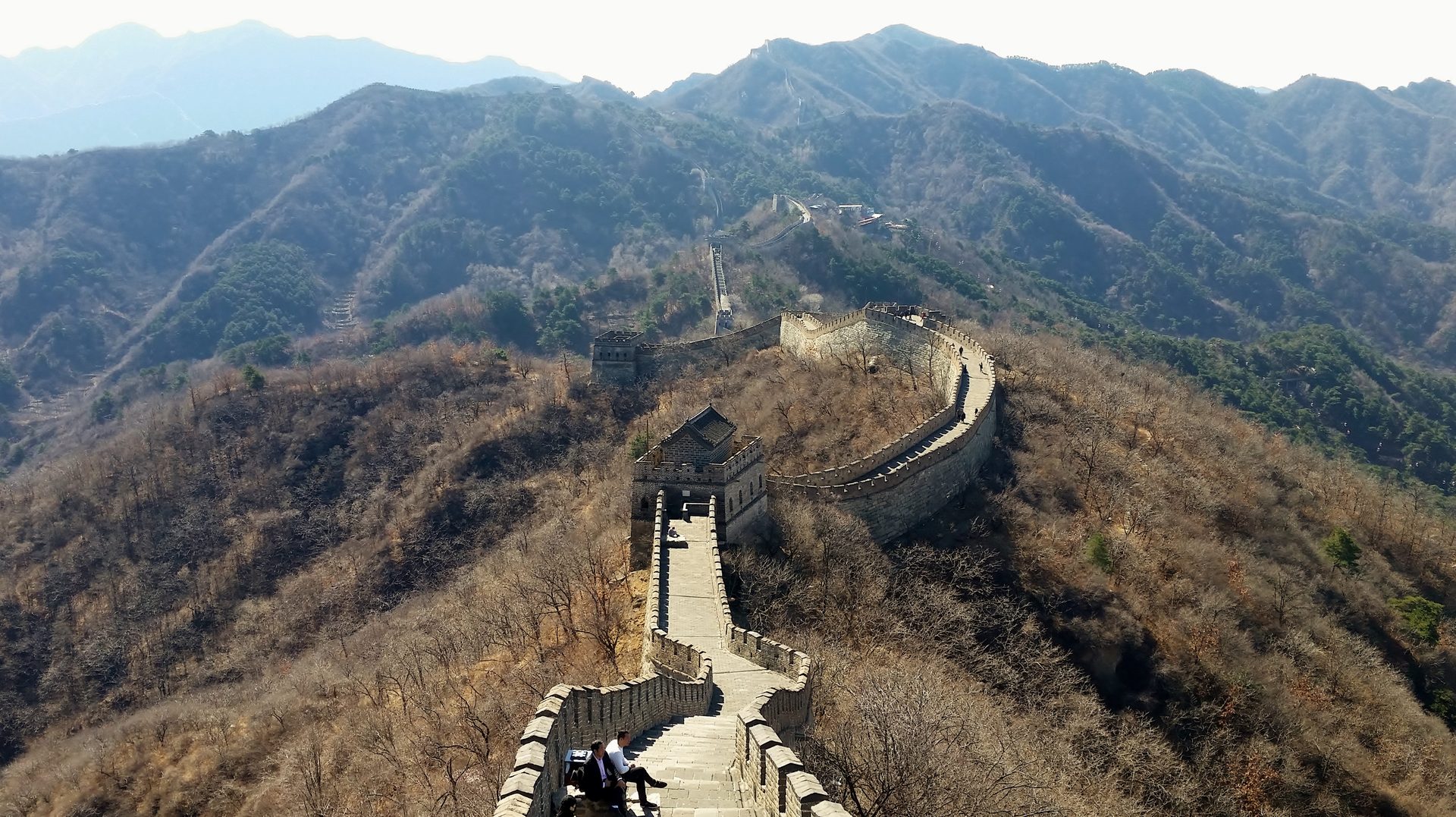 Mutianyu Great Wall snaking over forested mountain ridges with stone watchtowers, Beijing — Photo: Steven Kevil / CC BY-SA 4.0 via Wikimedia Commons